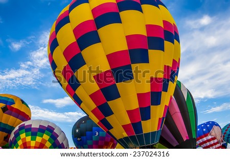Colorful hot air balloons preparing for lift off.