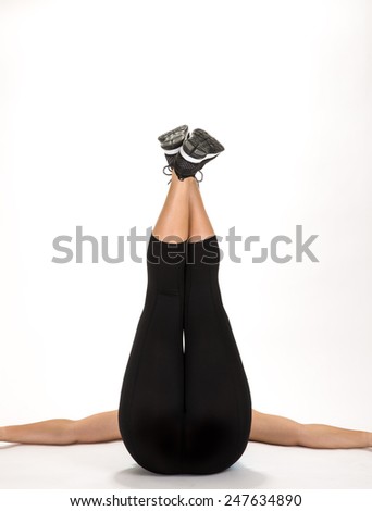 Young woman stretching legs up in the air view from bottom.