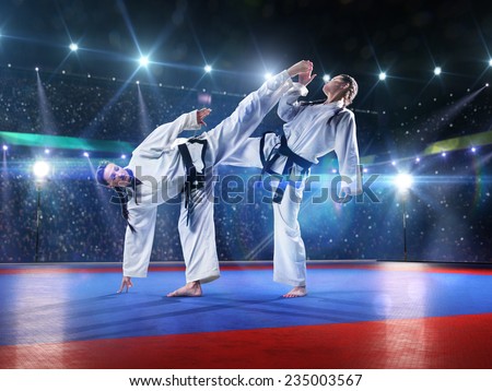 Two professional female karate fighters are fighting on the grand arena