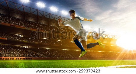 Soccer player in action on night stadium background panorama