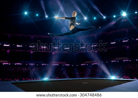 Young girl is jumping on the trampoline