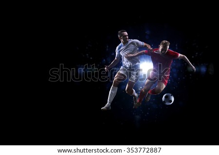 Soccer players in action over black background