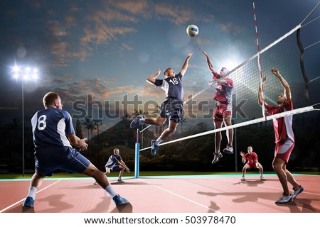 Professional volleyball players in action on the open air court