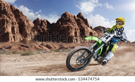 Professional dirt bike rider racing on the desert