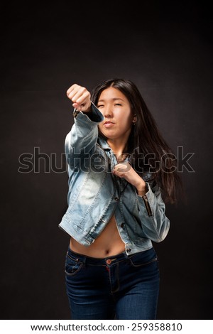 Oriental girl posing in studio as street fighter