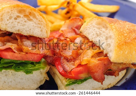 Baguette sandwiches with fried ham on blue plate