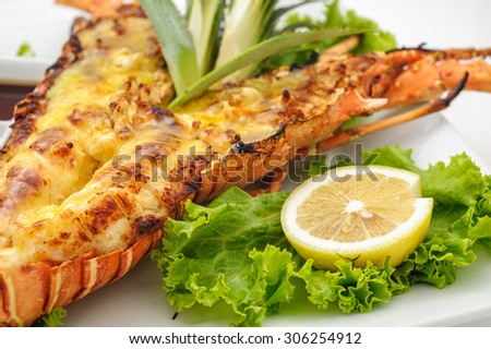 Grilled lobster with lemon isolated on white