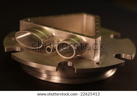 This is a picture of a custom milled or machined part. Machine shops use manufacture these types of custom parts with CNC machines, lathes, mills and turning centers.