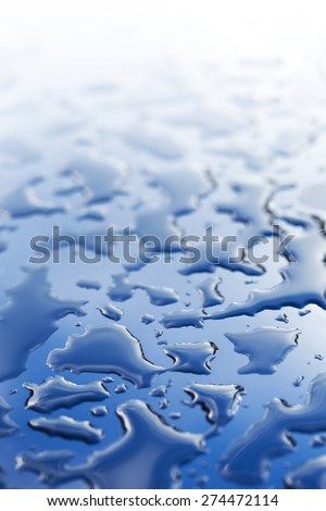 Splattered water drops, on glassy surface. Abstract background