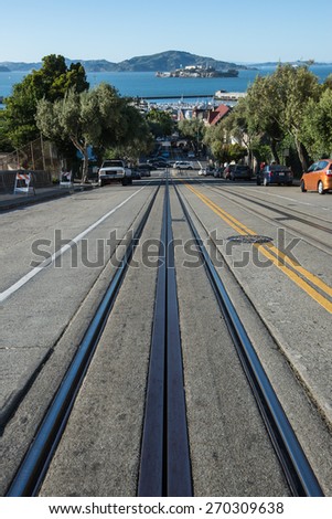 Powell Hyde cable car railway, descends a steep hill overlooking Alcatraz prison and SF bay on April 13, 2015 in San Francisco, USA