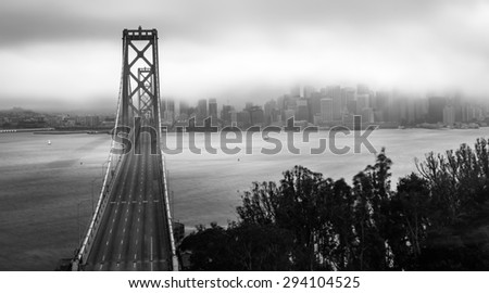Bay Bridge and Downtown San Francisco covered by fog black and white