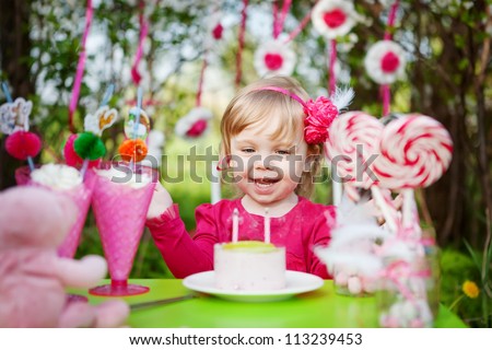 happy girl with birthday cake outdoors