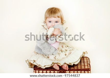 little girl hugging toy bear