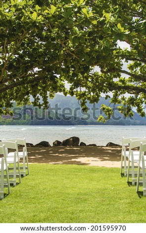 Looking down the aisle of empty seats at the scene of an upcoming destination wedding at Hanalei Bay in Kauai.
