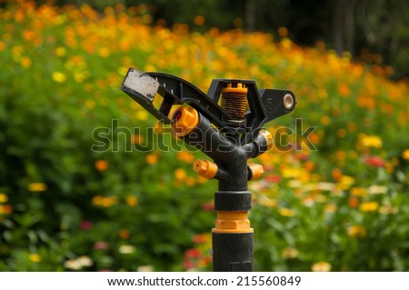 Sprinkler in flower field