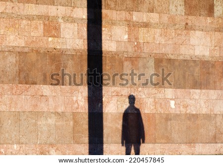 Man shadow on  marble wall