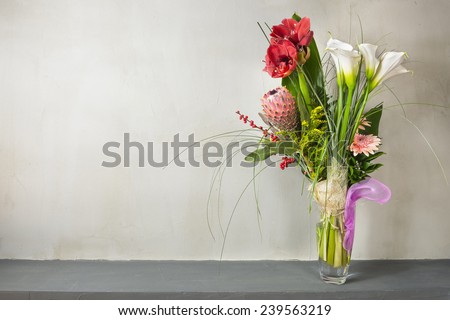 Colorful flowers bouquet in a vase on a gray background