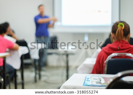 Abstract blur people in classroom education concept with projector / Blur people in meeting room /  Thai people