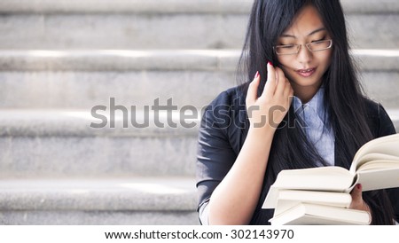 Portrait of a young woman holding a books