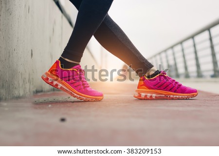 fitness, sport, training, people and lifestyle concept- Women legs with shoes and sun