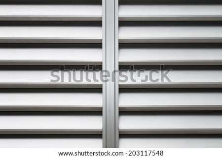 The  aluminum louver window as long as the background of the wall.