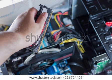 The technical is fixing computer RAM.