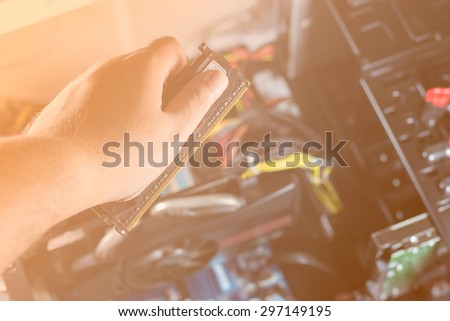Technician hand to fix computer.With orange color filter