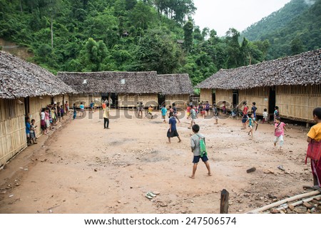 Mae Hong Son, Thailand - August 22, 2013: Burmese refugee students playing football in a school in Ban Mae Surin temporary shelter in Mae Hon Son, Thailand