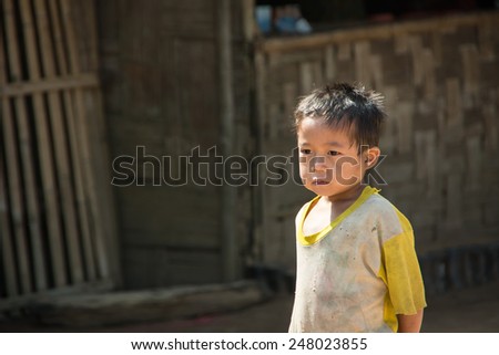Mae Hong Son, Thailand - October 10, 2013: An unidentified Burmese refugee boy with curious face in Ban Mai Nai Soi temporary shelter in Mae Hong Son, Thailand