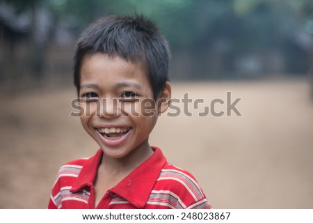 Mae Hong Son, Thailand - August 23, 2013: An unidentified Burmese refugee boy smiling in a morning in Ban Mae Surin temporary shelter in Mae Hong Son, Thailand