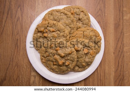 Oatmeal cookies with Butterscotch chips arranged on a paper plate, ready to serve.