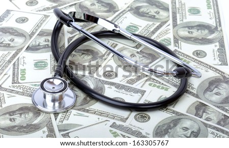 concept of medical costs with a stethoscope on dollar bills