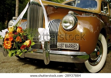 stock photo with flowers decorated oldtimer car at marriage