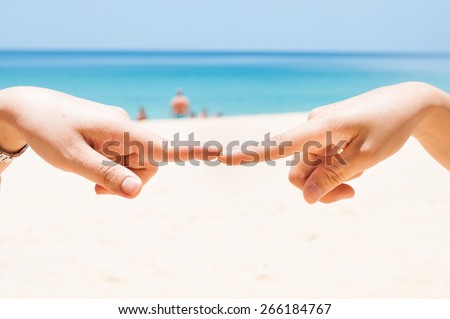Finger touch with two hand on the beach.Show the ties.Connection or contact symbol.