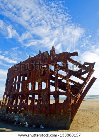 Rusty Wreckage of a Ship on a Beach on the Oregon Coast USA