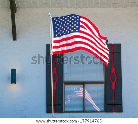 American Flag Reflecting in the Window of a Storefront in Leavenworth WA USA
