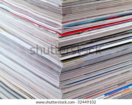 A stack of magazines filling the frame from top to bottom focus on corner edge