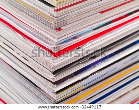 A stack of magazines filling the frame from top to bottom focus on corner edge