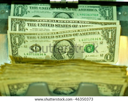 An electronic money counter processing US $1 bills