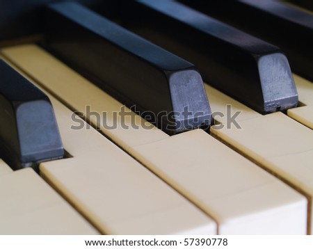 Piano keys of a very well loved and often played piano showing some wear and cracking.