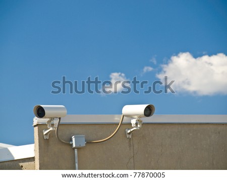 Security Cameras Performing Surveillance on the Side of a Building