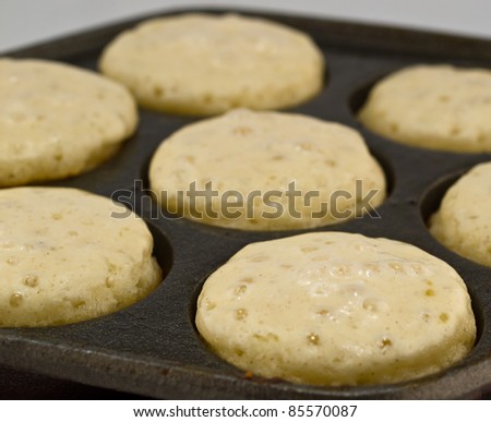 A Batch of Aebelskivers Cooking in a Pan