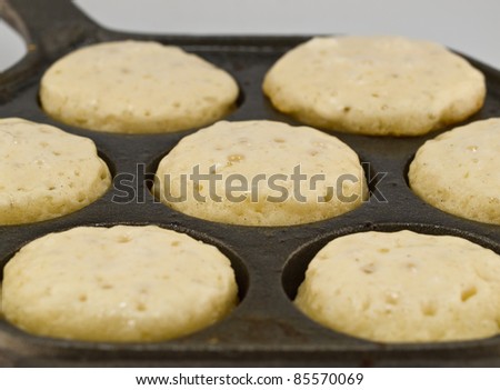 A Batch of Aebelskivers Cooking in a Pan