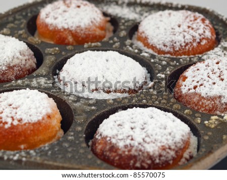 A Pan of Freshly Cooked Aebelskivers with Powdered Sugar