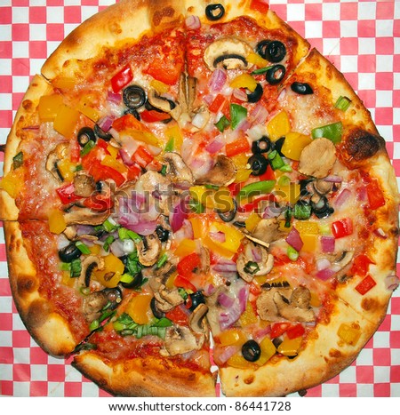 A Fresh and Healthy Vegetable Pizza on Red Checked Paper