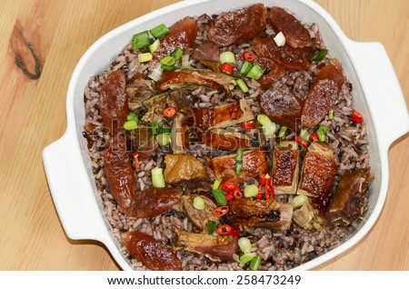 Aromatic steamed rice with waxed duck, smoked duck and chinese sausage / Aroma meat rice / Traditional chinese meal served during the cold winter months