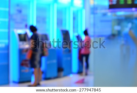 Blur background people withdraw money at ATM