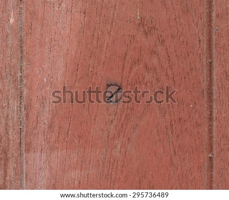Nail in wood surface