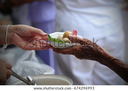 hand give food to hands of a beggar
