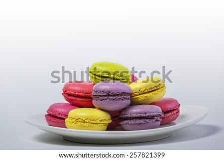 French macaron cakes on white plate with white background